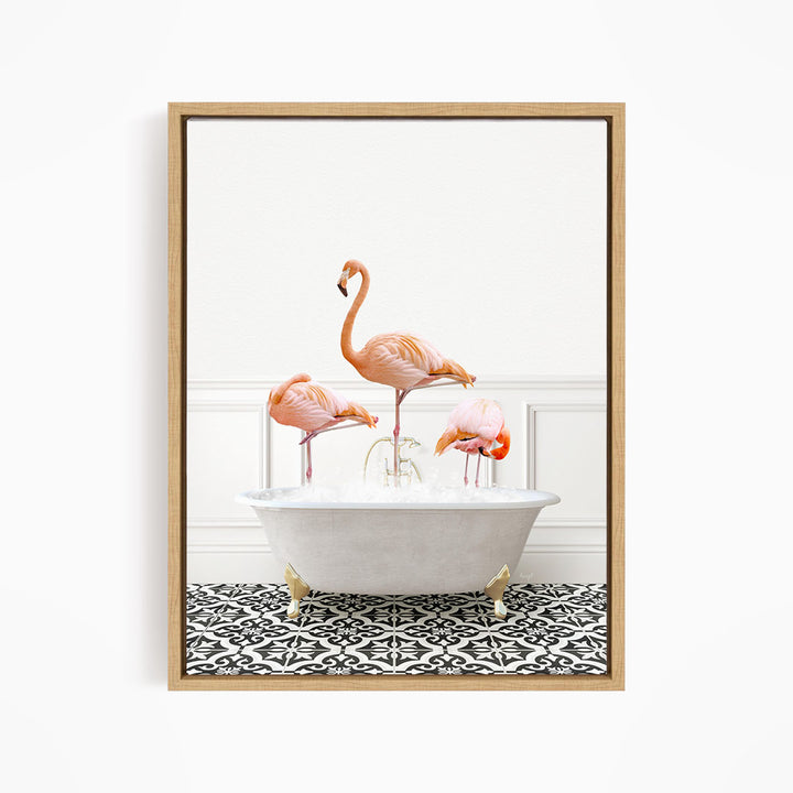A framed image of three flamingos standing in a white bathtub filled with water, creating a whimsical and playful scene.