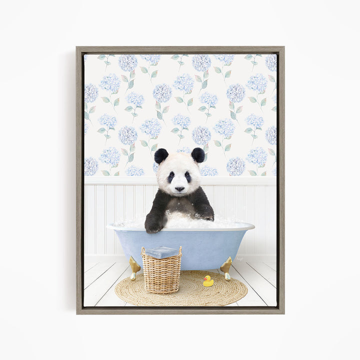 A panda bear sitting in a blue bathtub filled with bubbles, surrounded by a wicker basket and yellow rubber ducks.