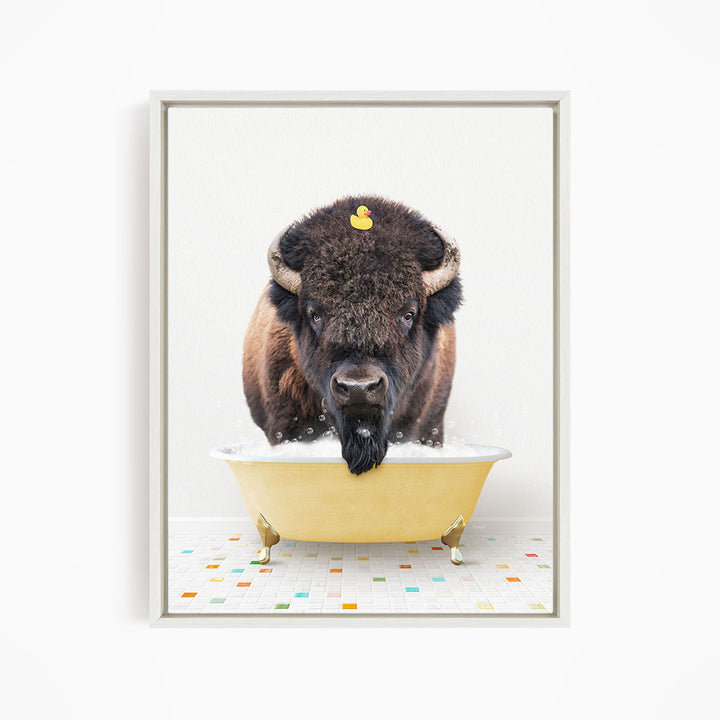 A buffalo with a yellow rubber duck sitting in a yellow bathtub.