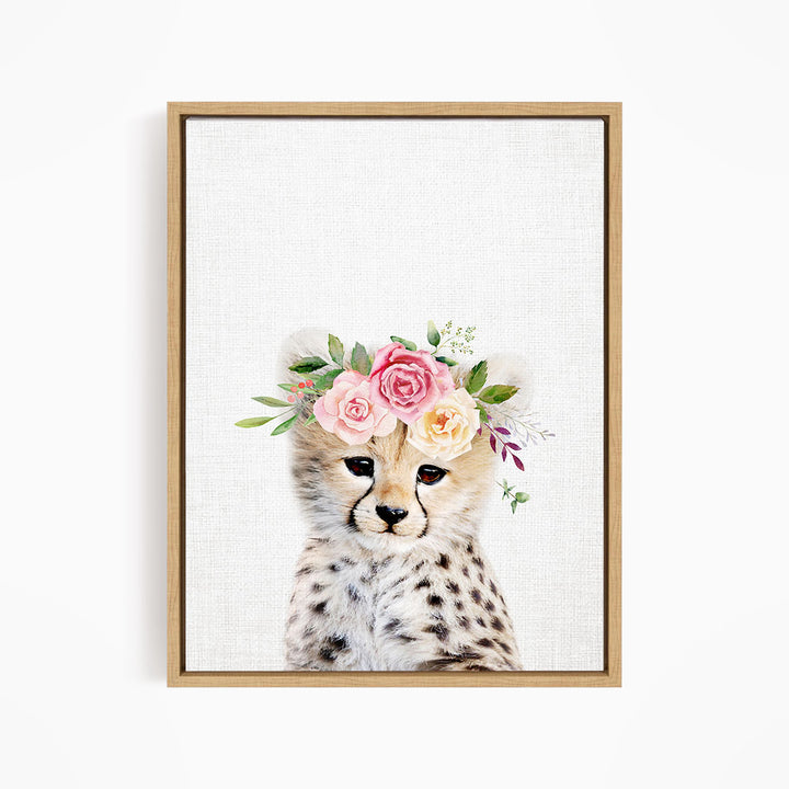 A cheetah wearing a floral crown on its head, with pink and yellow flowers and green leaves.