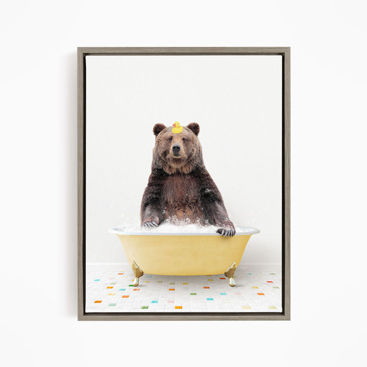 A brown bear sitting in a yellow bathtub filled with water, with a yellow rubber duck floating on the water.