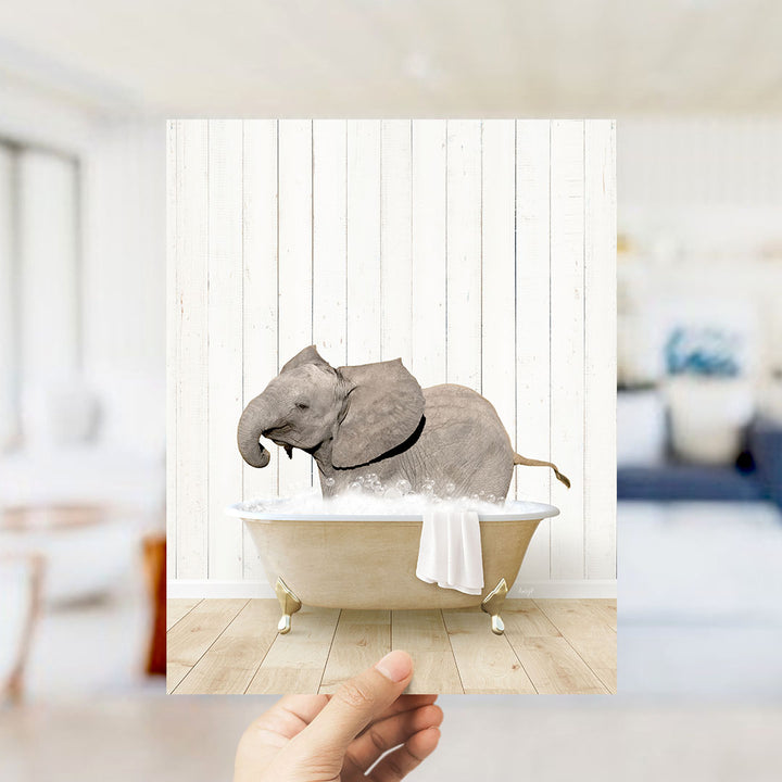 A gray elephant is sitting in a bathtub filled with water, surrounded by a white wooden wall.