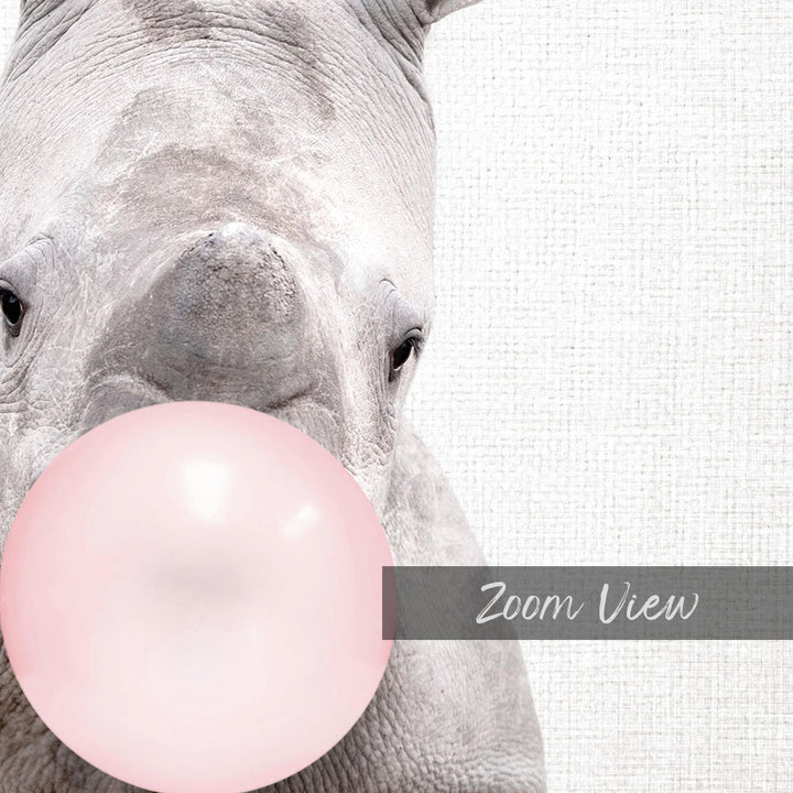 A close-up of a rhinoceros blowing a pink bubble with its mouth, with a text overlay that reads "Zoom View".