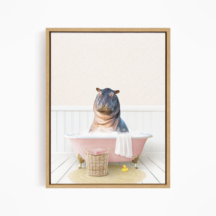 A hippopotamus sitting in a pink bathtub filled with water, surrounded by a basket of toys and a yellow rubber ducky.