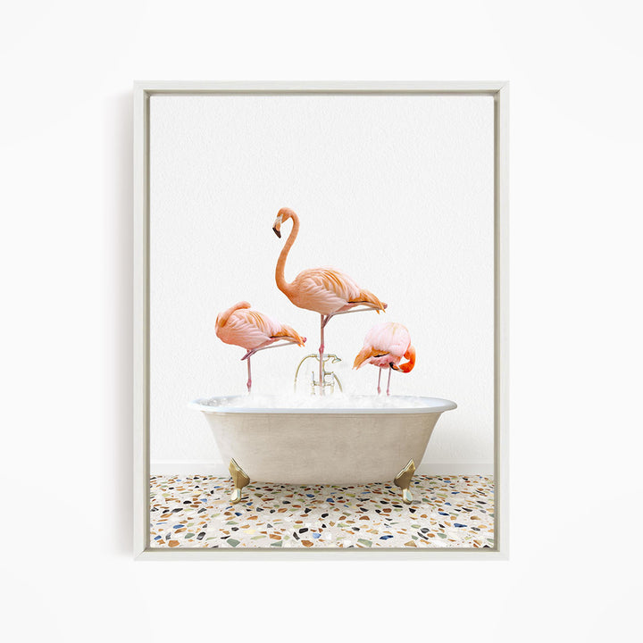 A framed image depicting three pink flamingos standing in a white bathtub filled with water.