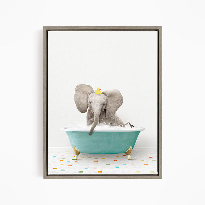 A gray elephant is sitting in a blue bathtub filled with water, with a yellow rubber duck floating on its head.