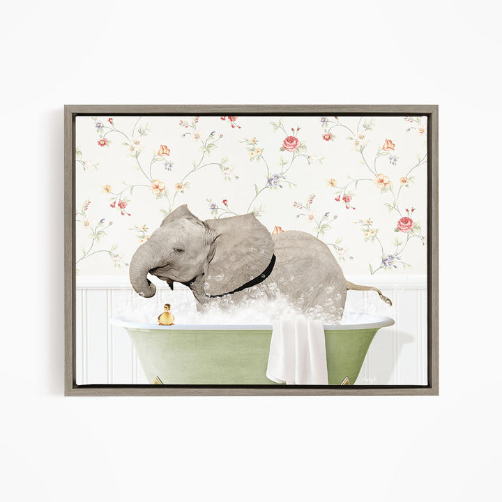 A gray elephant is sitting in a green bathtub filled with water, surrounded by a floral patterned wall.