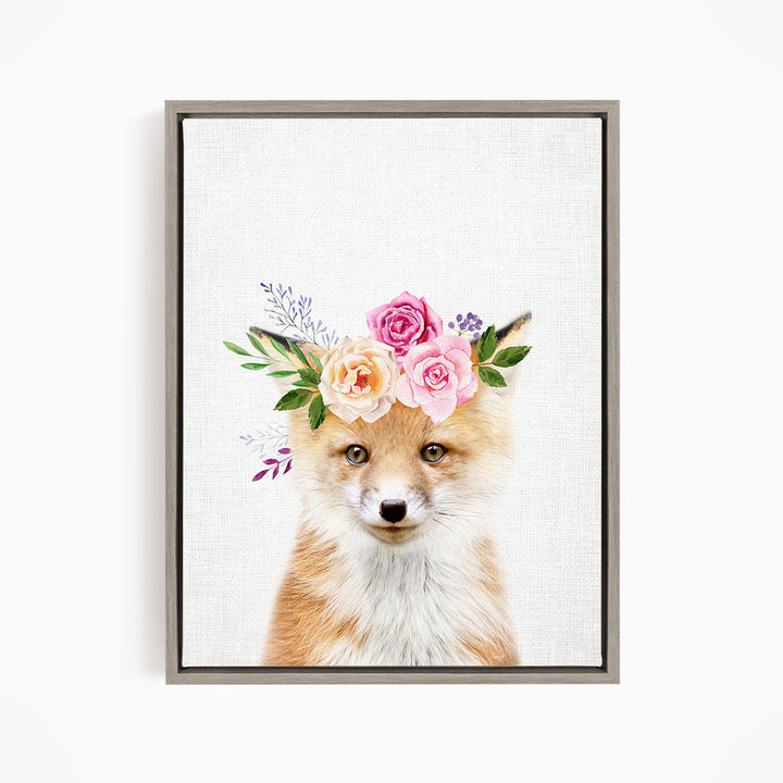 A fox wearing a floral crown of pink and orange roses and green leaves.