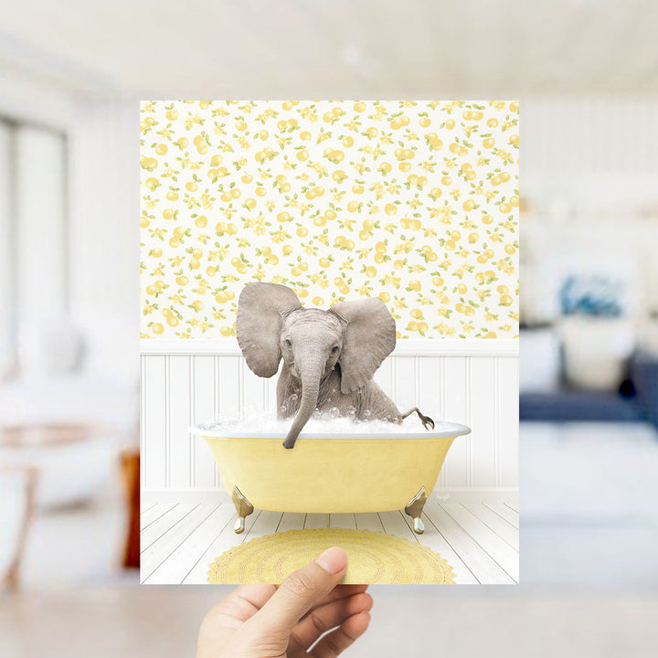 A gray elephant sitting in a yellow bathtub filled with water, surrounded by a yellow and white patterned wall.