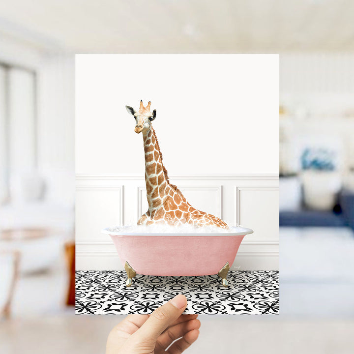 A giraffe sitting in a pink bathtub filled with bubbles, creating a whimsical and playful scene.