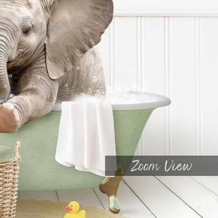 A baby elephant sitting in a green bathtub, surrounded by a yellow rubber duck and a white towel.