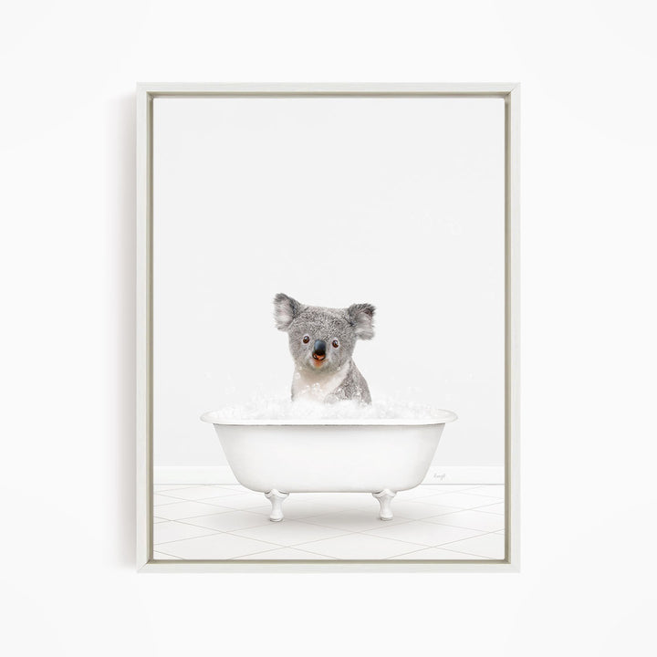 A koala sitting in a white bathtub filled with water.