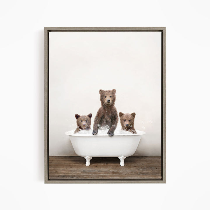 Three adorable brown bears sitting in a white bathtub, enjoying a relaxing bath together.