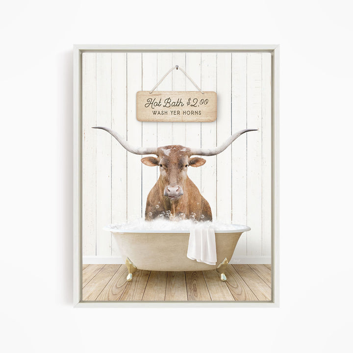 A brown bull with large horns is sitting in a white bathtub, with a sign above it that reads "Hot Bath $2.00 WASH YER HORSES".