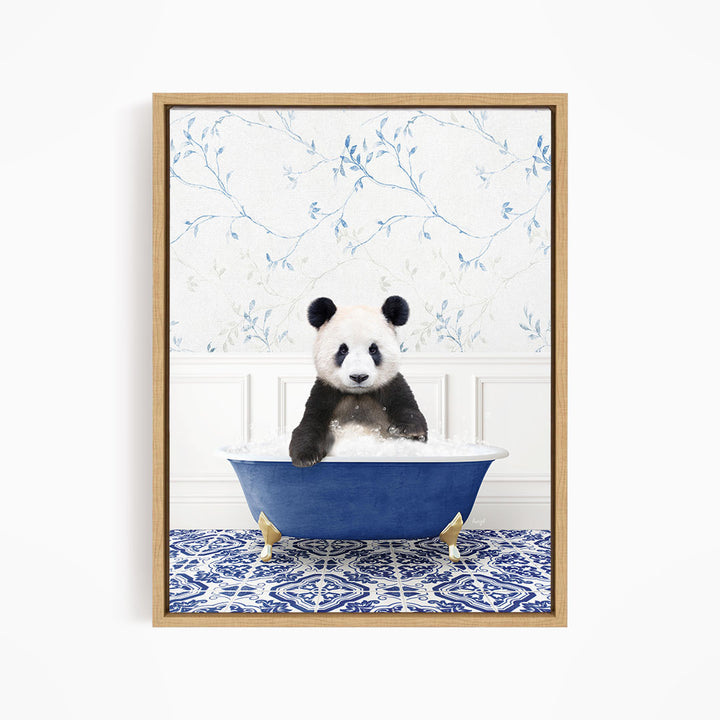 A panda bear sitting in a blue bathtub, surrounded by a blue and white patterned rug and a floral wallpaper background.