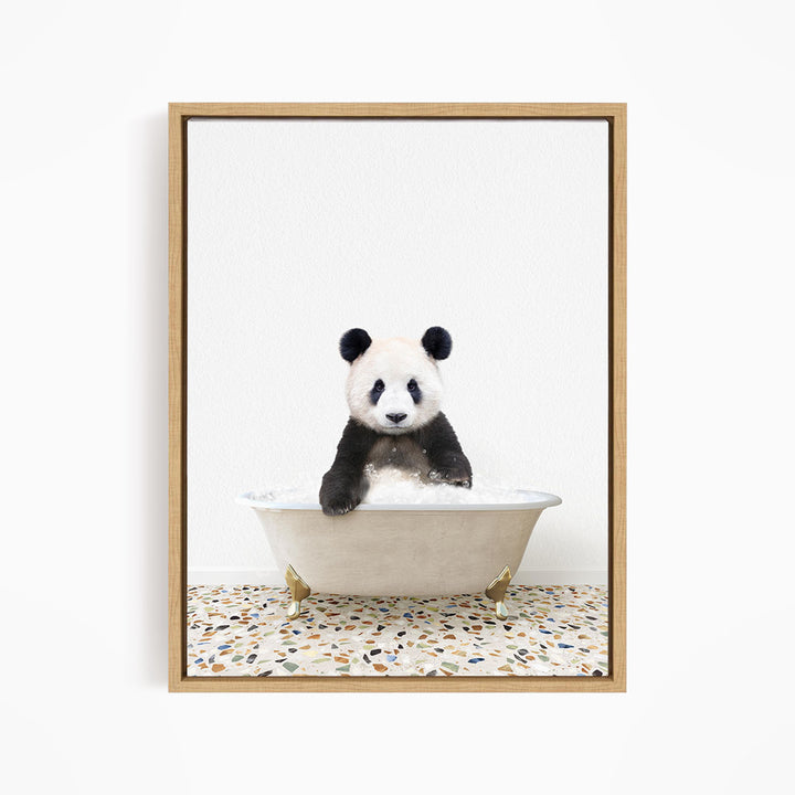 A panda bear sitting in a white bathtub filled with water, looking directly at the camera.