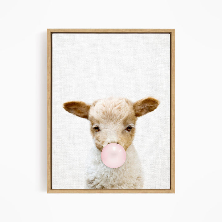 A cute lamb blowing a bubble with a pink bubble gum bubble.