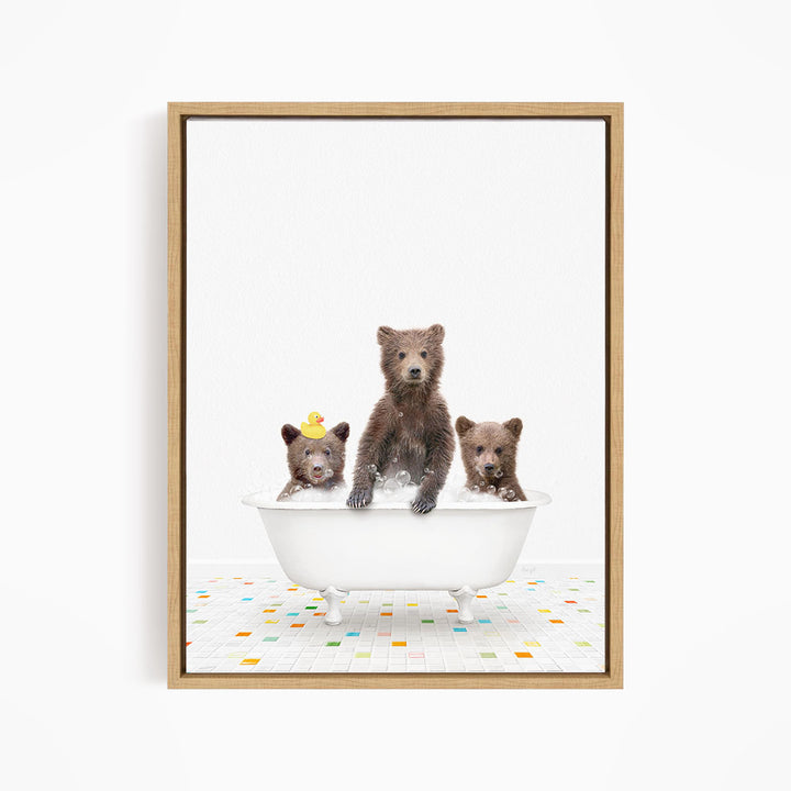 A framed image depicting three bears sitting in a white bathtub, with one bear sitting in the center and the other two bears sitting on either side.