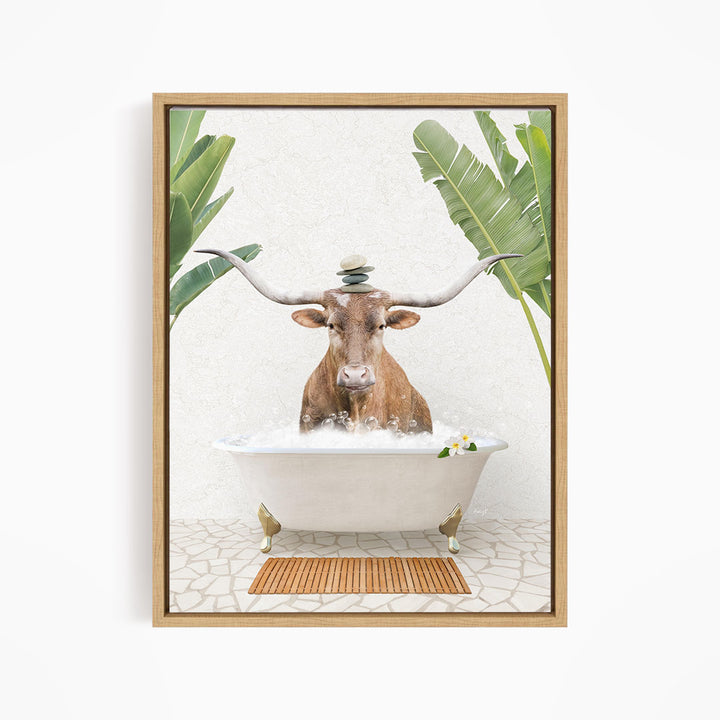 A bull with large horns is sitting in a white bathtub filled with water, surrounded by tropical plants and a wooden mat on the floor.