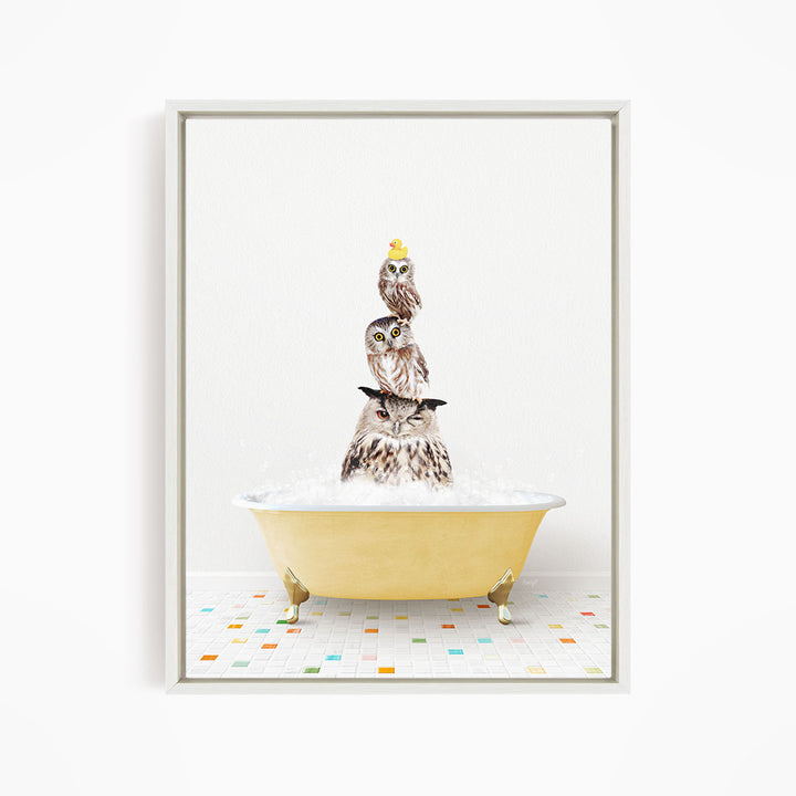 A framed image depicting three owls sitting in a yellow bathtub, with one of the owls wearing a yellow hat.