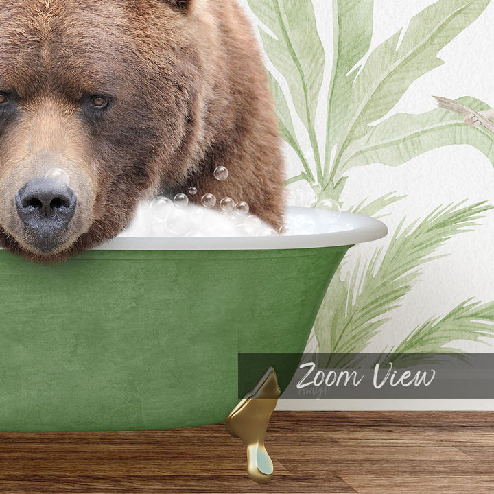 A close-up of a brown bear sitting in a green bathtub filled with bubbles, with a palm tree patterned wall in the background.