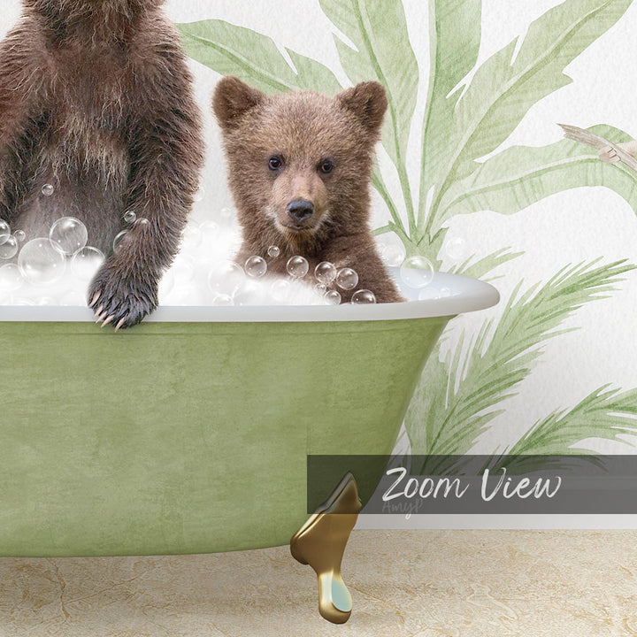 A baby bear sitting in a green bathtub filled with bubbles, with a palm tree wallpaper in the background.