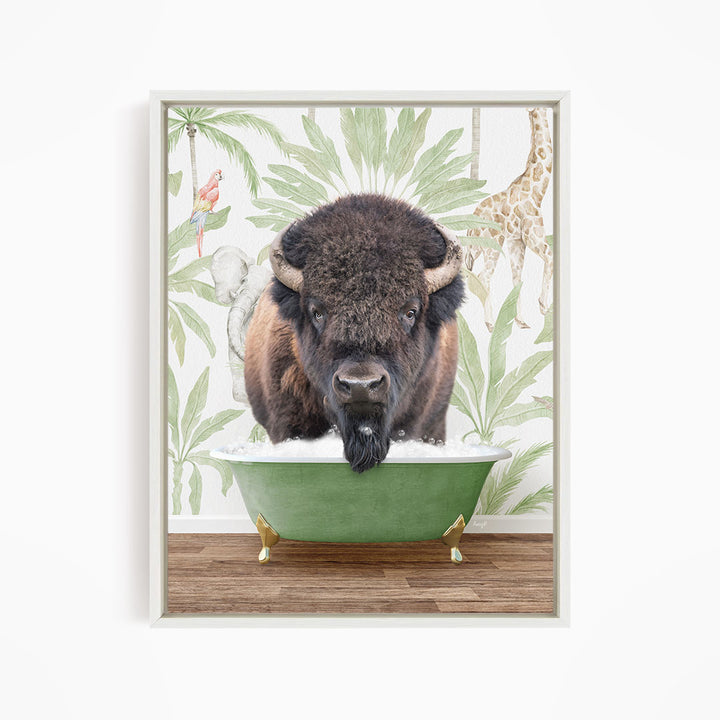 A buffalo with a black mane and horns is standing in a green bathtub, surrounded by tropical foliage and a giraffe in the background.