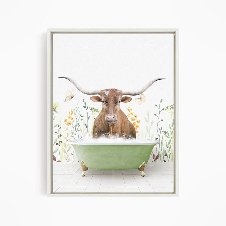 A brown cow with large horns is sitting in a green bathtub filled with water, surrounded by flowers and plants.