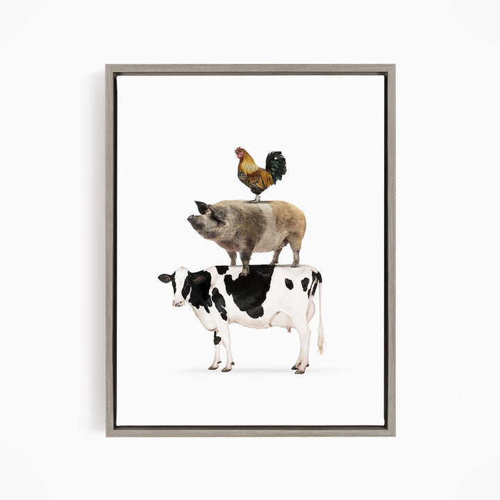 A framed illustration depicting a cow, pig, and rooster standing on top of each other.