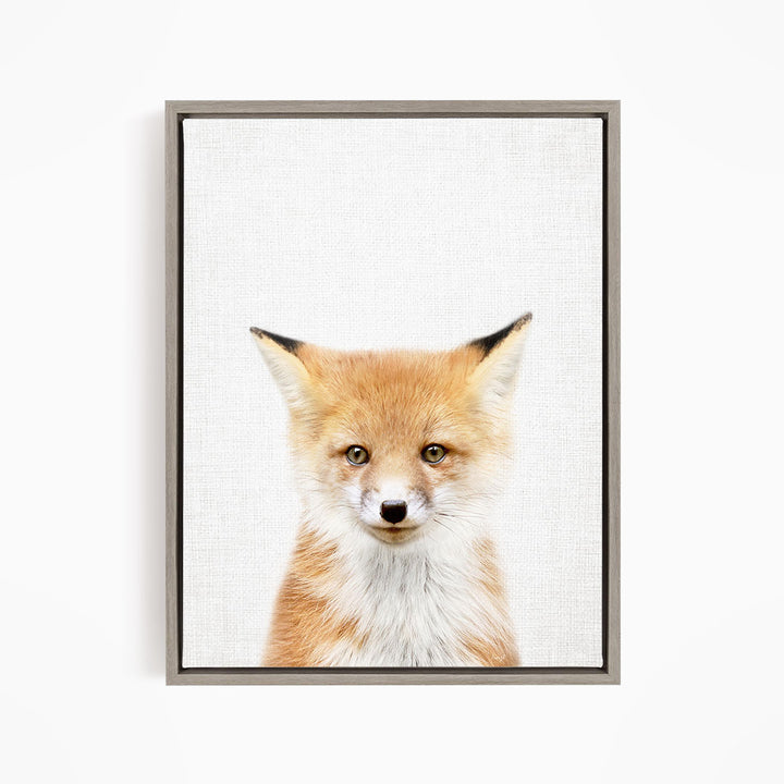 A framed print of a young fox with a friendly expression, looking directly at the camera.