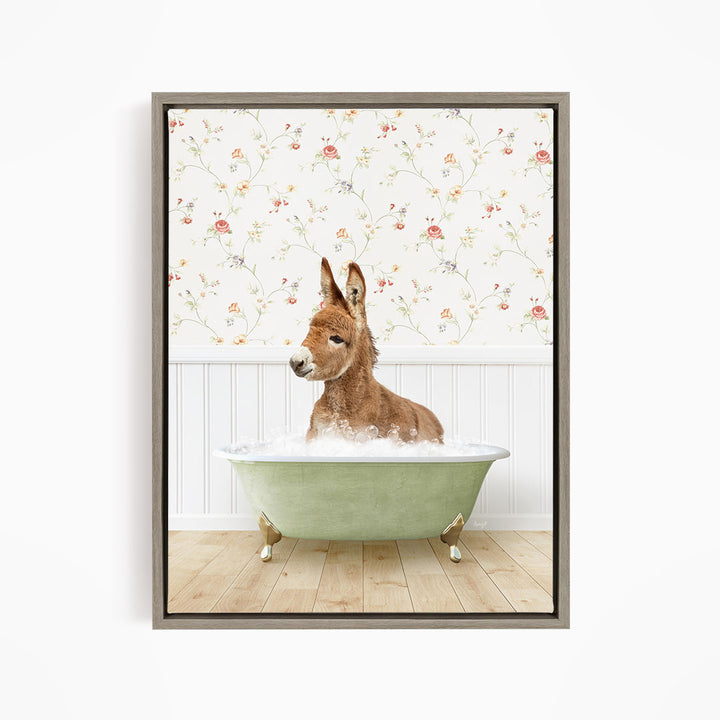 A donkey is sitting in a green bathtub filled with water, surrounded by a floral wallpaper.