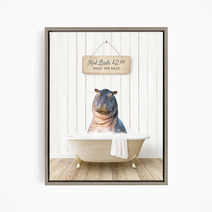 A framed image of a hippopotamus sitting in a bathtub, with a wooden sign above it that reads "Hot Bath $2.00 WASH YER BACK".