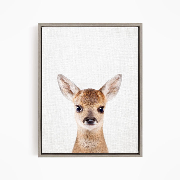 A framed print of a deer's head with large, alert eyes and a small nose, set against a plain white background.
