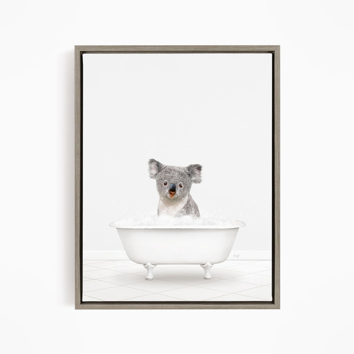 A koala sitting in a white bathtub filled with water.