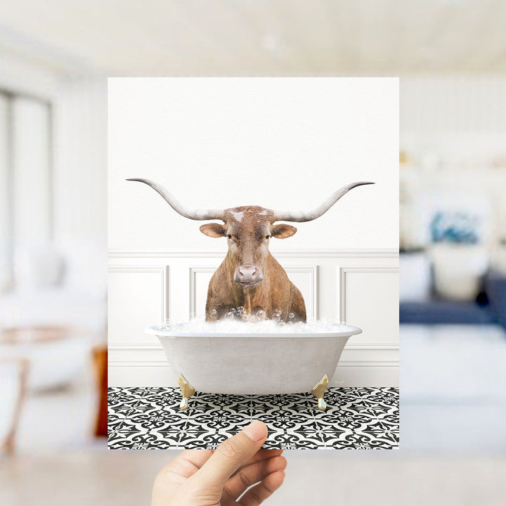 A brown bull with long horns is sitting in a white bathtub filled with bubbles, creating a whimsical and playful scene.