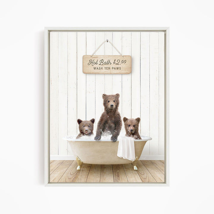 A framed image depicting three brown bears sitting in a bathtub, with a sign above them that reads "Hot Bath $2.00 WASH YOUR Paws".