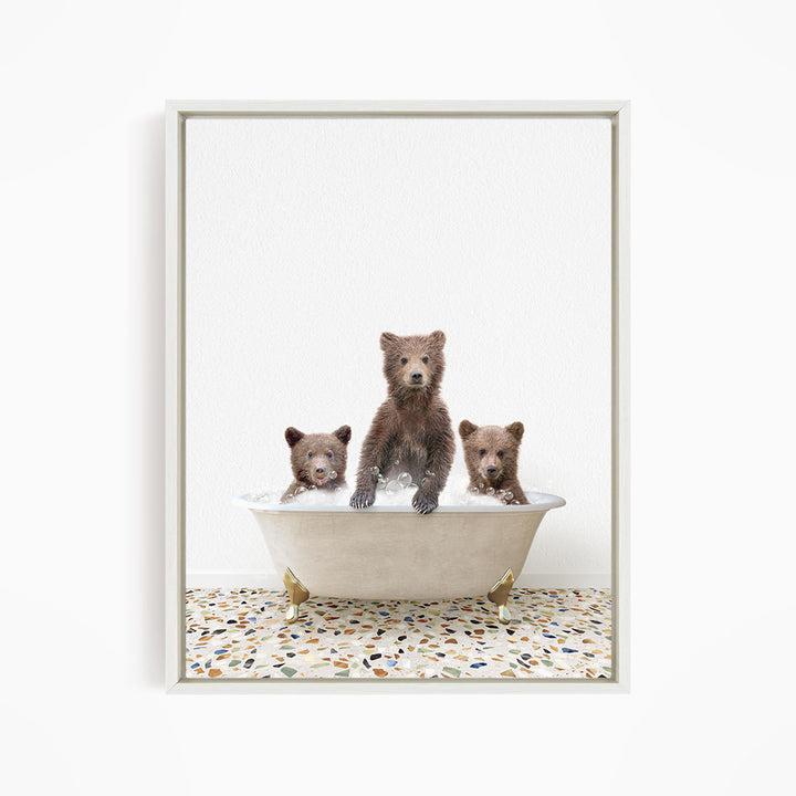 Three adorable brown bears enjoying a relaxing bath in a white bathtub, with a mosaic floor beneath them.