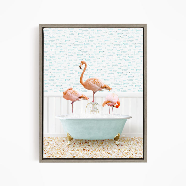 A framed image depicting three flamingos standing in a bathtub filled with water, with a fish-themed wallpaper in the background.
