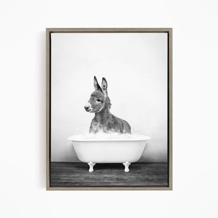 A donkey is sitting in a bathtub filled with water, creating a playful and whimsical scene.