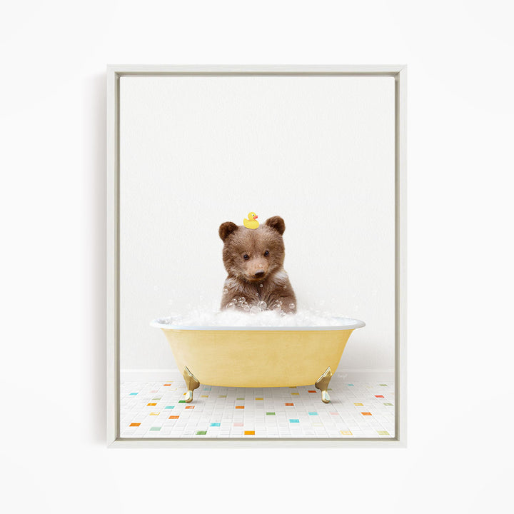 A brown bear sitting in a yellow bathtub filled with bubbles, with a rubber duck floating on the water.