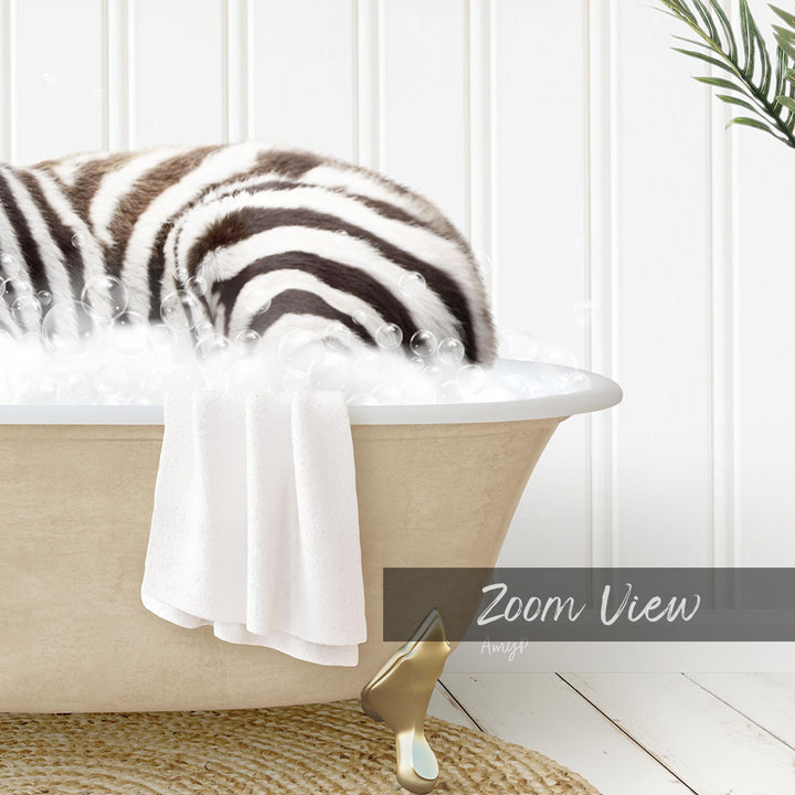 A zebra lying in a bathtub filled with bubbles, with a towel and a gold object nearby.