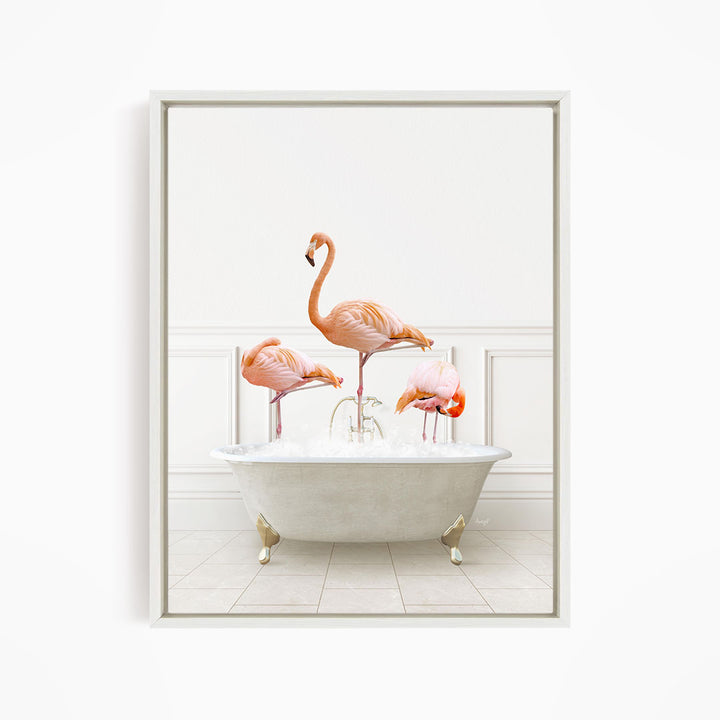 A framed image depicting three pink flamingos standing in a white bathtub filled with water.