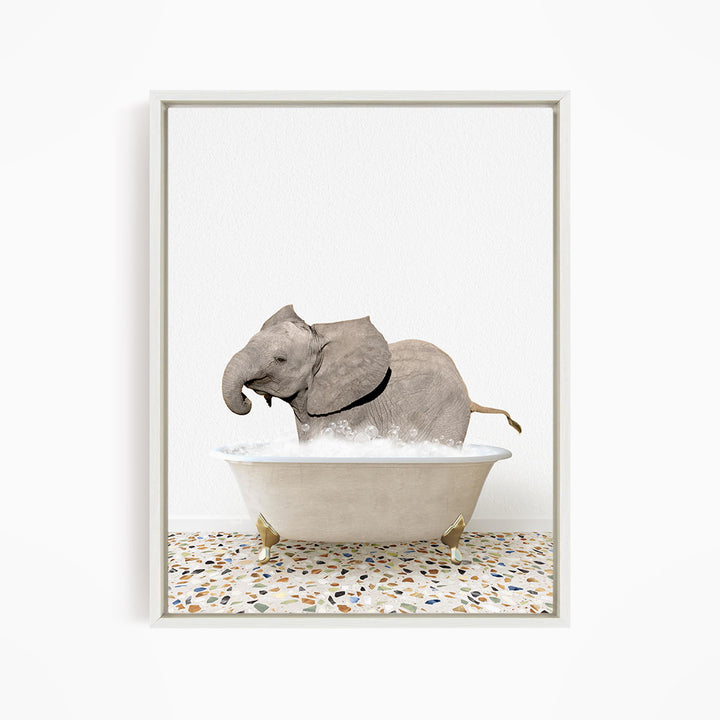 A gray elephant is sitting in a white bathtub filled with water, creating a whimsical and playful scene.