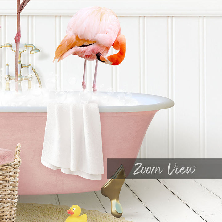 A pink flamingo stands in a bathtub filled with water, surrounded by a yellow rubber duck and a white towel.