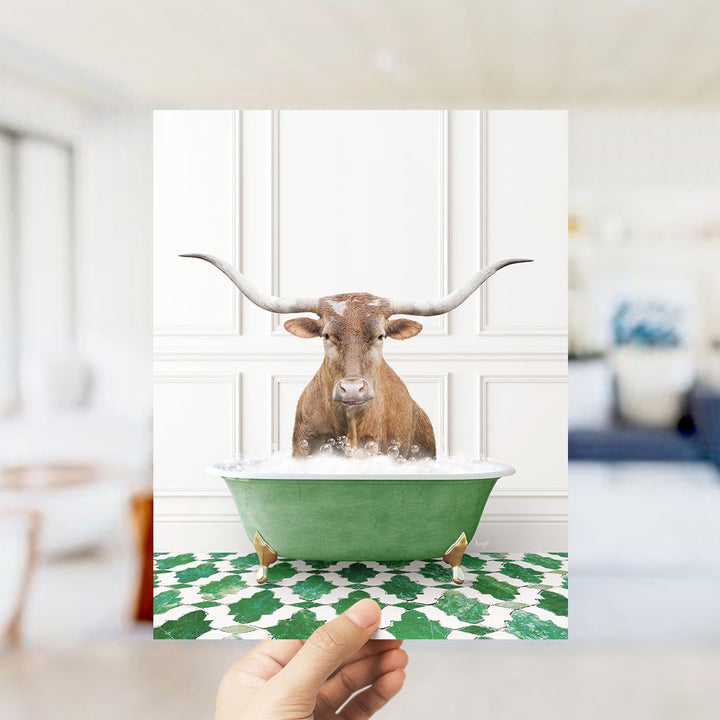 A brown cow with long horns is sitting in a green bathtub filled with bubbles, creating a whimsical and playful scene.