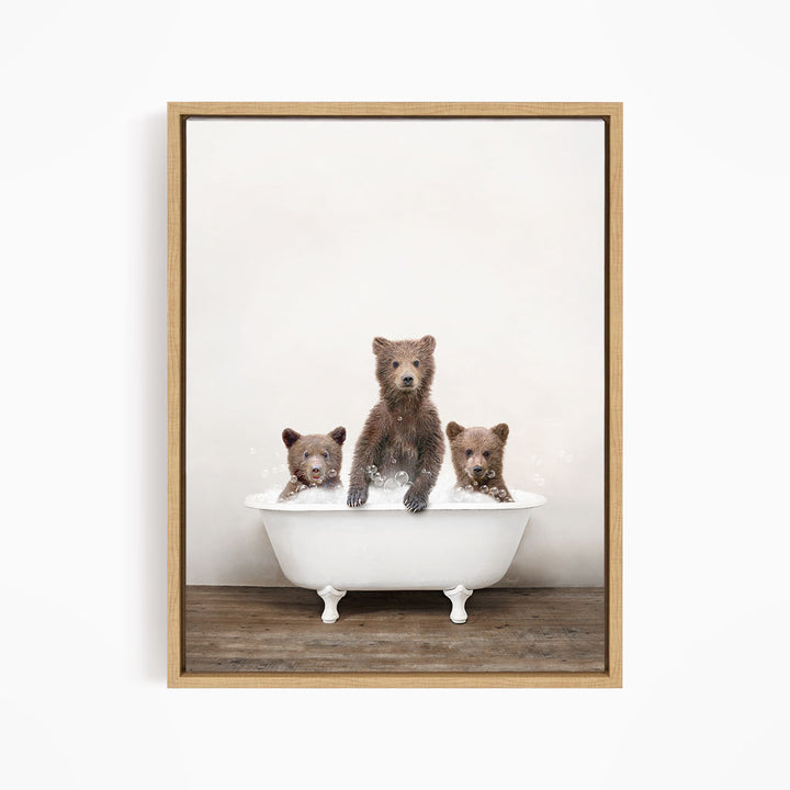 Three adorable brown bears sitting in a white bathtub, enjoying a relaxing bath together.