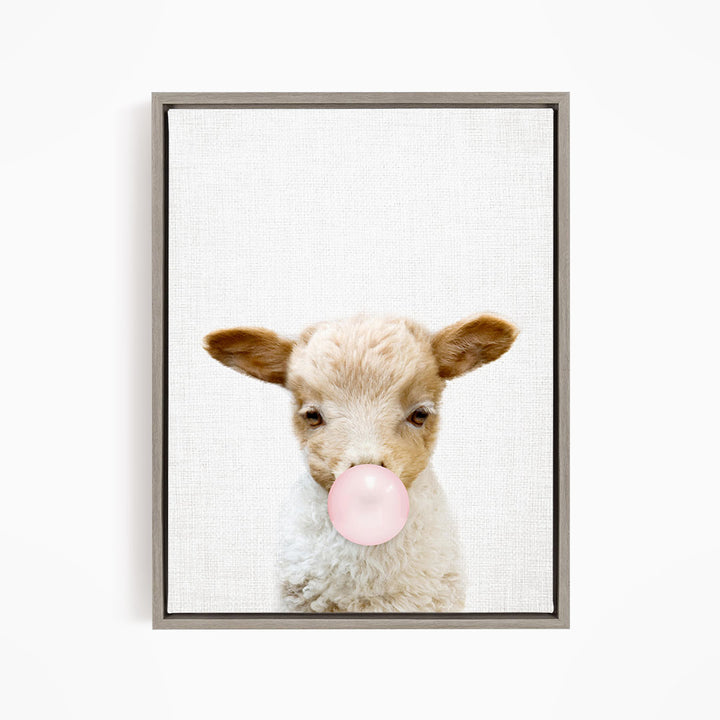 A cute lamb blowing a bubble with a pink bubble gum bubble.