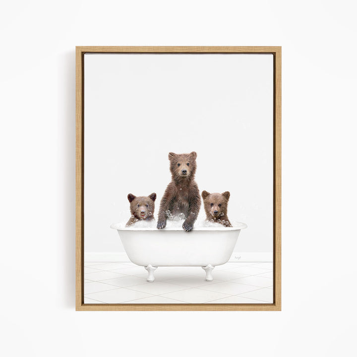 A framed image depicting three brown bears sitting in a white bathtub, with one bear sitting at the center and the other two bears sitting on either side.