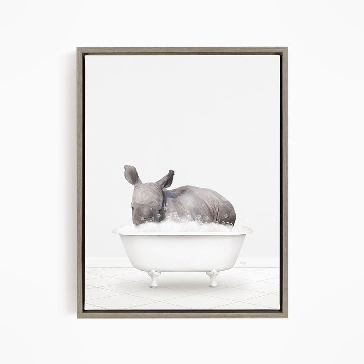 A rhinoceros is sitting in a white bathtub filled with water, creating a whimsical and playful scene.