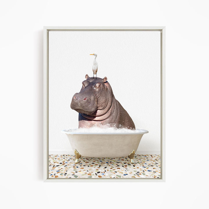 A large hippopotamus is sitting in a bathtub filled with water, with a white bird perched on its head.